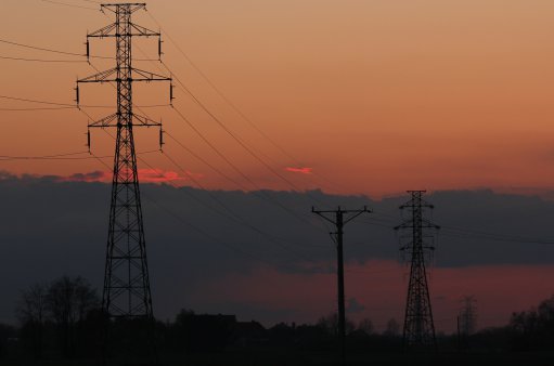 zdjęcie przedstawia linię energetyczną na tle zachodu słońca